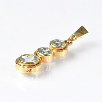 Lot 937 - A 9ct gold pendant set with three aquamarines...