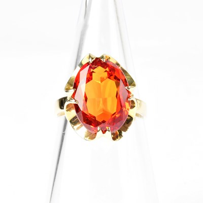 Lot 860 - A 9ct gold ring set with orange sapphire, in a...
