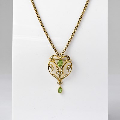Lot 939 - An Edwardian 9ct gold pendant set with peridot...