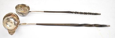 Lot 738 - Two white metal wine ladles, both set with...