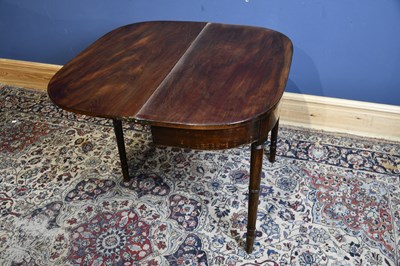Lot 6696 - A 19th century mahogany tea table on turned...