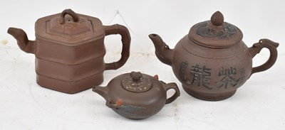 Lot 651 - A group of three Yixing teapots.