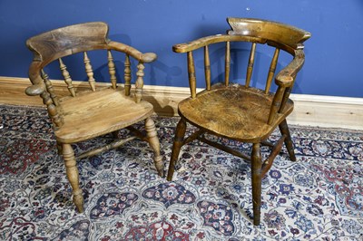 Lot 6578 - Two elm seated smoker's bow back elbow chairs...