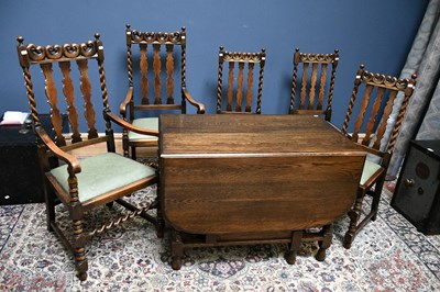 Lot 2540 - A 1920s oak drop leaf dining table on barley...