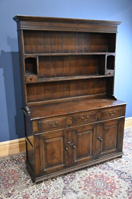 Lot 6722 - A reproduction dark oak dresser with boarded...