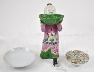 Lot 654 - A Chinese Famille Rose kneeling figure (badly...