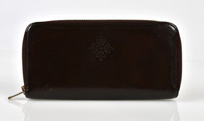 Lot 956 - PATEK PHILIPPE; a soft brown leather wallet...