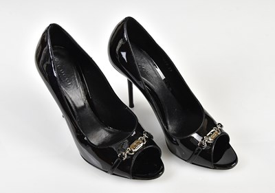 Lot 1057 - GUCCI; a pair of black patent leather stiletto...