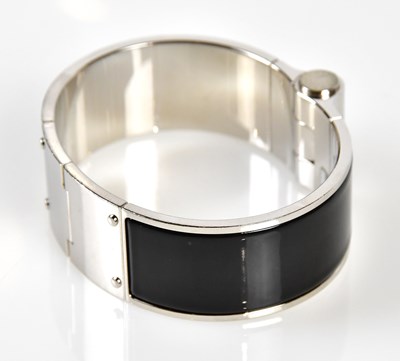Lot 855 - HERMÈS; a black enamel and silver Charniere...