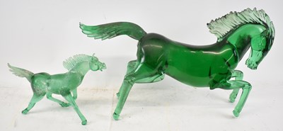 Lot 580 - Two green glass models of horses, the largest...
