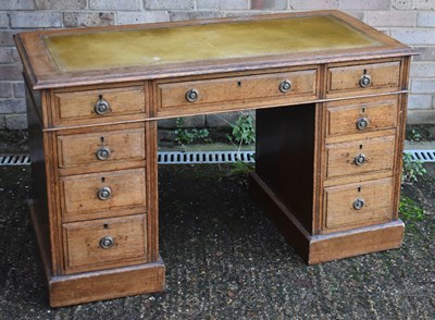 Lot 21 - An early 20th century oak twin pedestal nine...