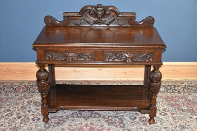 Lot 6514 - A c1900 carved oak Flemish style side table...