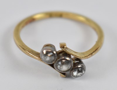 Lot 792 - An 18ct yellow gold three stone ring, size K,...
