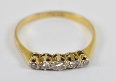 Lot 795 - An 18ct yellow gold ring set with five small...