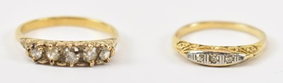Lot 808 - A five stone yellow metal diamond ring, size P,...