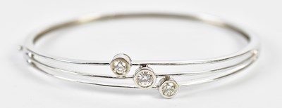 Lot 40 - An 18ct white gold three stone diamond set...