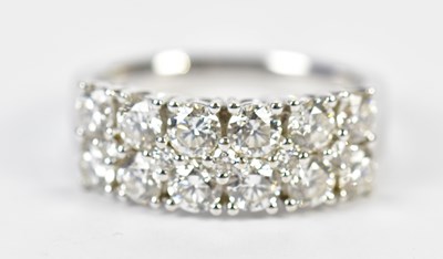 Lot 64 - An 18ct white gold diamond half eternity ring...