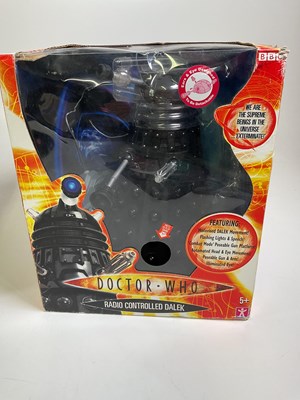 Lot 81 - Two boxed 14" remote control toy Daleks in...