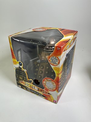Lot 81 - Two boxed 14" remote control toy Daleks in...