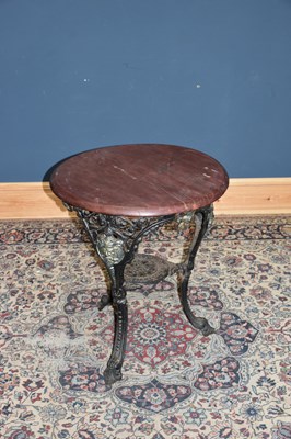 Lot 6462 - A cast iron pub table decorated with the green...