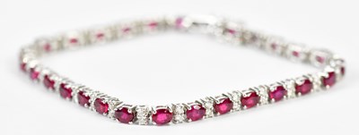 Lot 508 - An 18ct white gold ruby and diamond line...