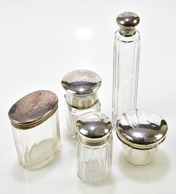 Lot 2212 - Five clear glass silver mounted toilet jars,...