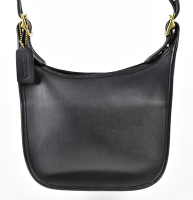 Lot 919 - COACH; a black leather shoulder bag with brass...