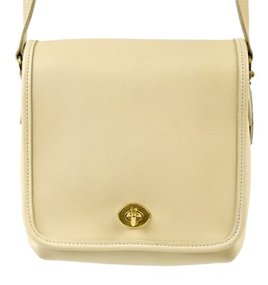 Lot 907 - COACH; an unused cream thick leather crossbody...