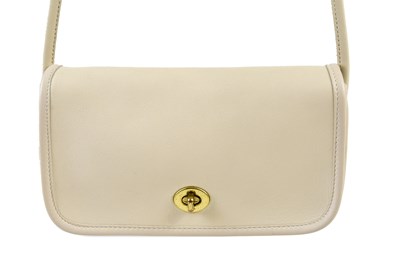 Lot 908 - COACH; an unused cream thick leather crossbody...