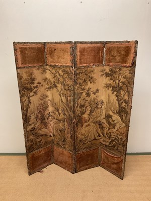 Lot 621 - A four panel folding screen with tapestry...