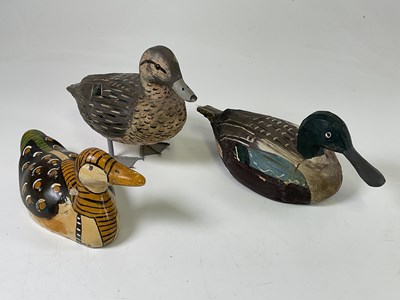 Lot 29 - Three hand painted wooden decoy ducks, the...