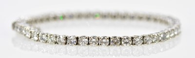 Lot 490 - An 18ct white gold diamond tennis bracelet set...