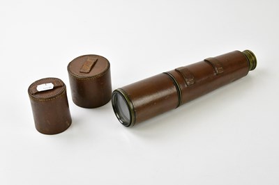 Lot 6349 - A leather cased brass two draw telescope.