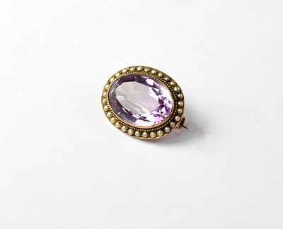 Lot 909 - A Victorian oval brooch set with large faceted amethyst stone