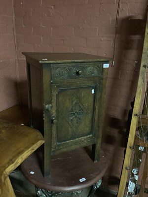 Lot 6751 - A 1950s carved oak pot cupboard with single...