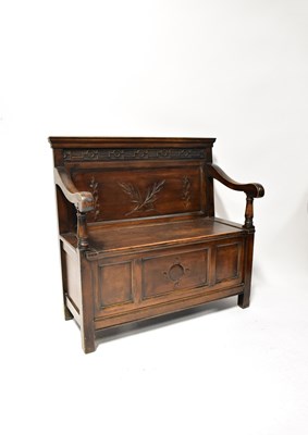 Lot 25 - A reproduction small settle with carved...