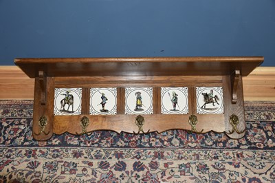 Lot 6498 - An oak wall mounted coat rack set with fire...