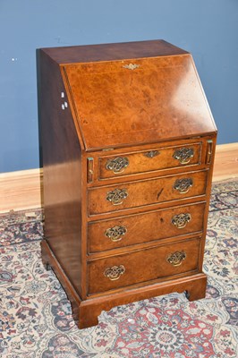 Lot 6752 - A reproduction yew four drawer bureau of small...
