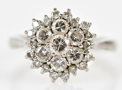 Lot 121 - An 18ct white gold and diamond domed cluster...