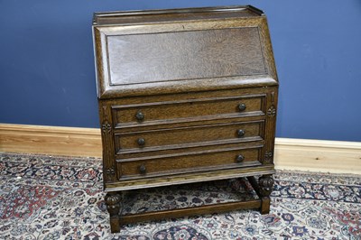 Lot 6593 - An early 20th century oak bureau with...