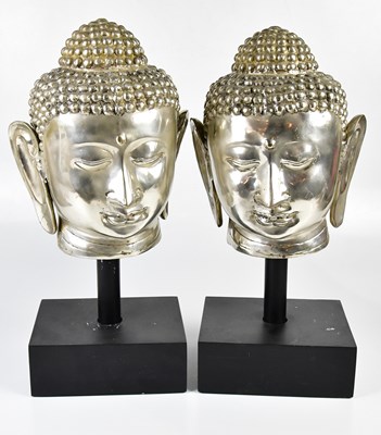 Lot 5165 - A pair of chromed Buddha heads, each on black...
