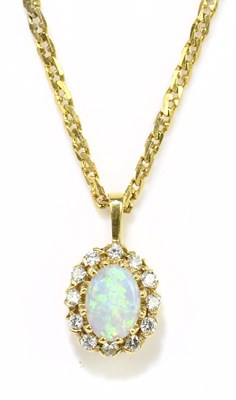 Lot 1357 - A 9ct yellow gold opal and diamond oval...