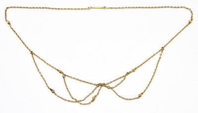 Lot 1369 - An Edwardian rose gold coloured swag drop...