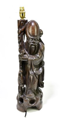 Lot 1207 - A Japanese carved hardwood lamp modelled as a...