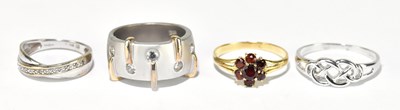 Lot 1557 - An 18ct yellow gold garnet set cluster ring,...
