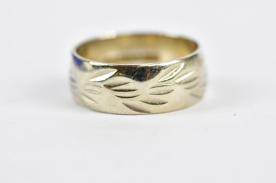 Lot 252 - A 9ct white gold engraved small wedding band,...