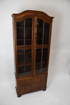 Lot 1655 - A 1920s oak two door display cabinet, with two...