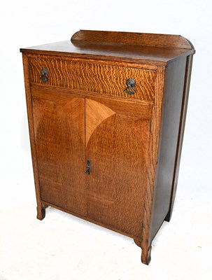 Lot 1651 - A late Art Deco oak cabinet, with single door...