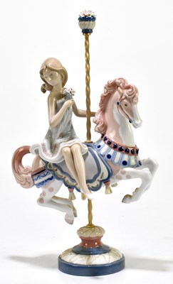 Lot 615 - LLADRO; a figure group of a girl holding a...