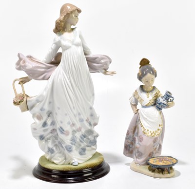 Lot 577 - LLADRO; a figure of a maiden with a basket of...
